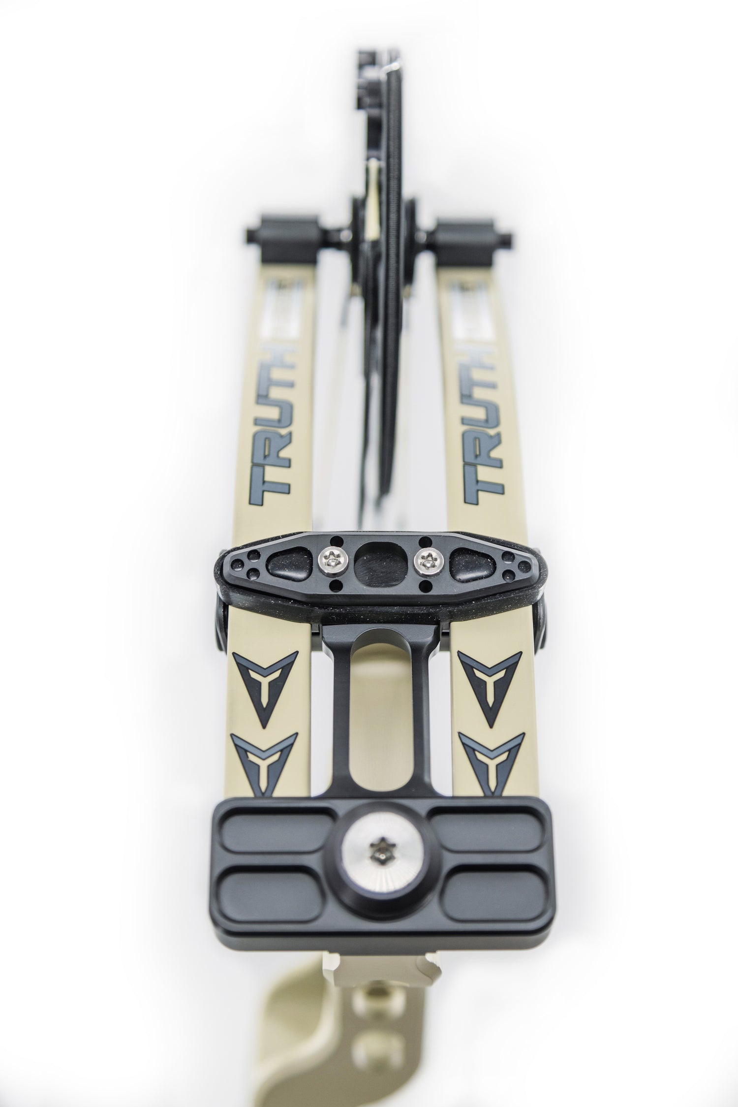 Close-up of a bow's limb pocket and cam system, featuring the brand "TRUTH" prominently displayed on sleek beige and black components.